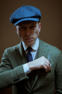 Мужчина в костюме и синей твидовой кепке восьмиклинке Келлс Hanna Hats